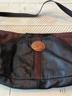 Used Black and Brown Leather Shoulder Bag with Decorative Medallion